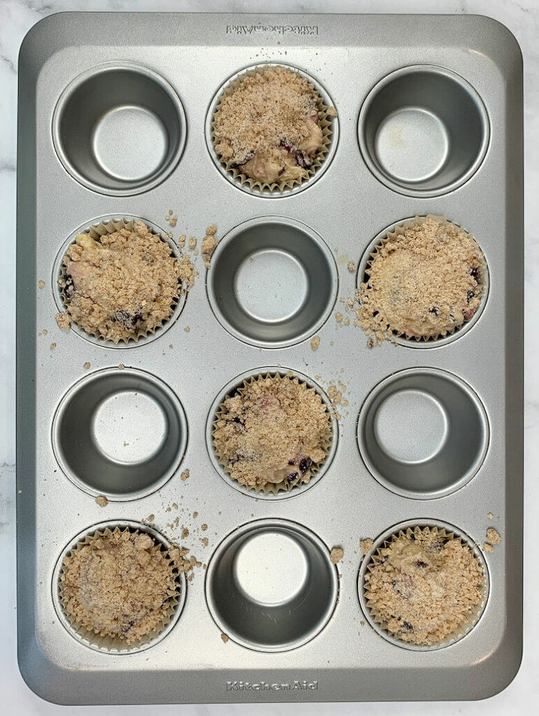 streusel on cherry muffins in muffin pan