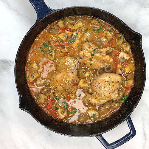 Chicken thighs back into stroganoff sauce in skillet.